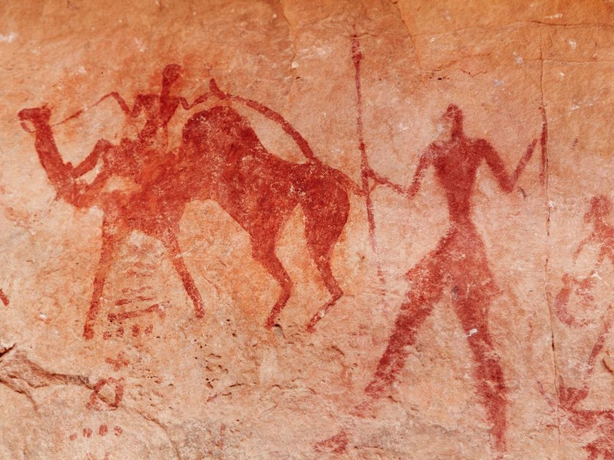 A cave painting showing a hunter and camel